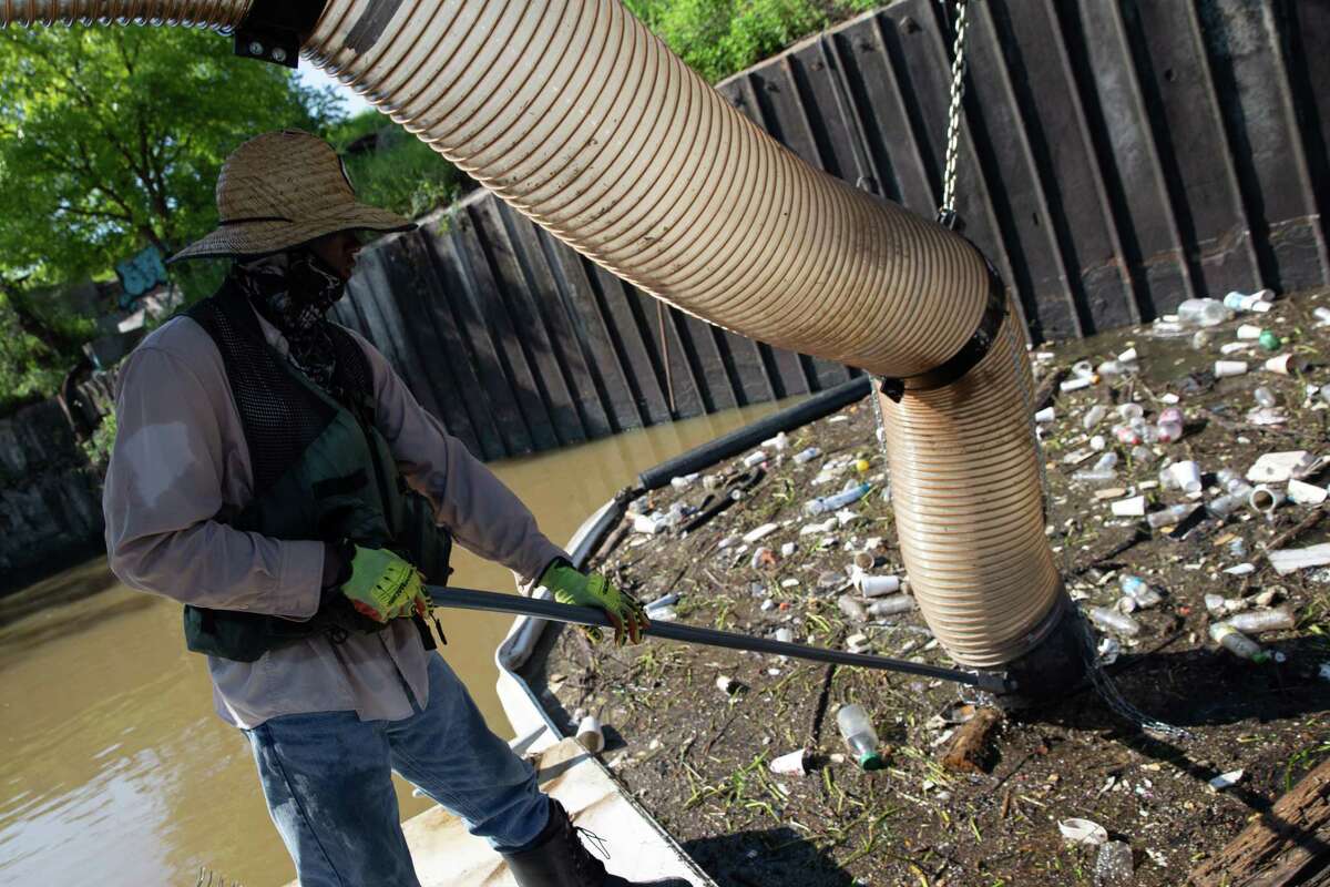 A custom-made boat found only in Houston vacuums mountains of litter from Buffalo Bayou