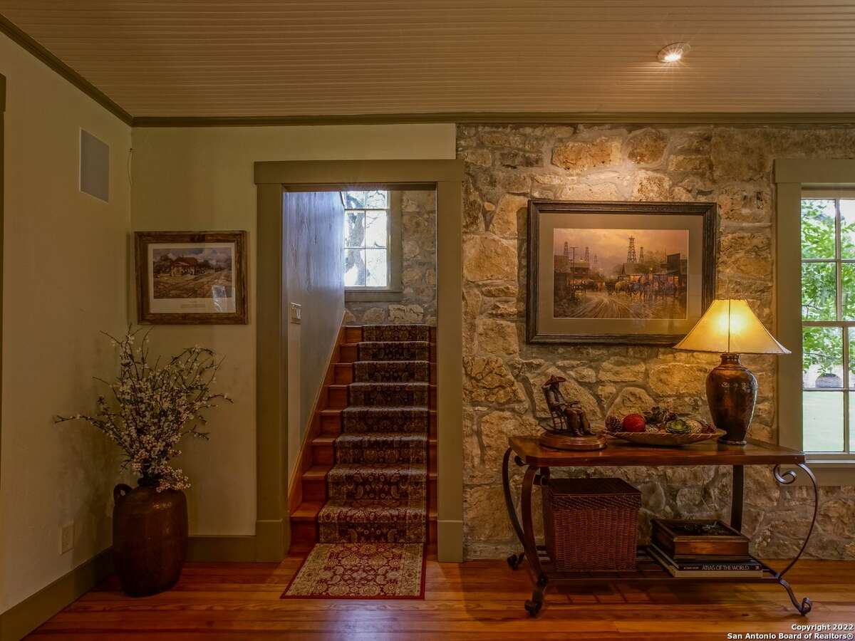 The property oat 35 Old San Antonio Rd. sits on 14.1 acres and includes two homes — one of which is a renovated 1890s era structure. The other is a 5,353-square-foot home with interior rock walls, four bedrooms, three full bathrooms and two partial bathrooms. 
