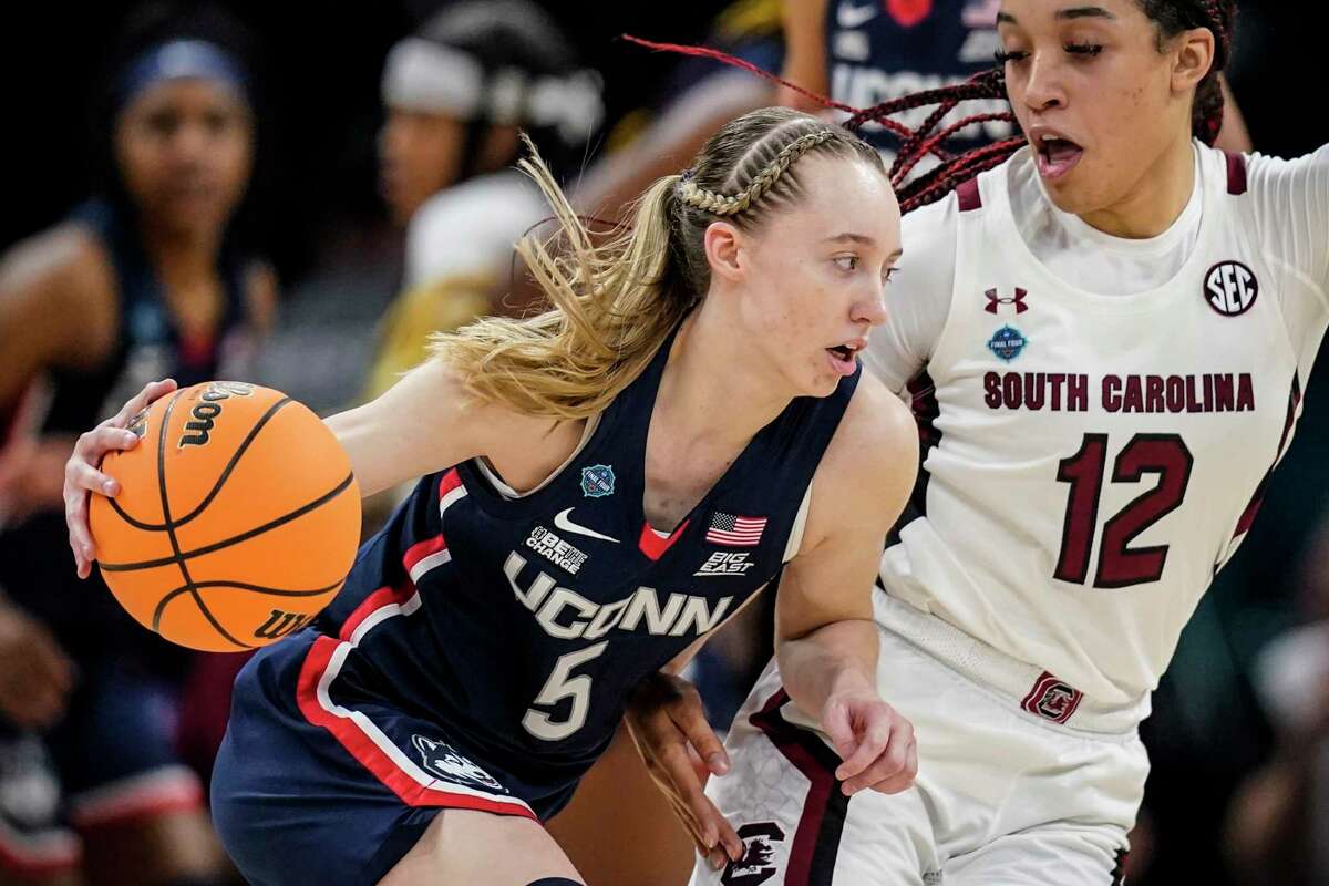 FILES - UConn's Paige Bookers will attempt to top South Carolina's Blair Beale at the Women's Final Four NCAA tournament on Sunday, April 3, 2022 in Minneapolis. Bookers tore the ACL in his left knee and will miss the entire 2022-23 season, the school announced Wednesday, Aug. 3, 2022.