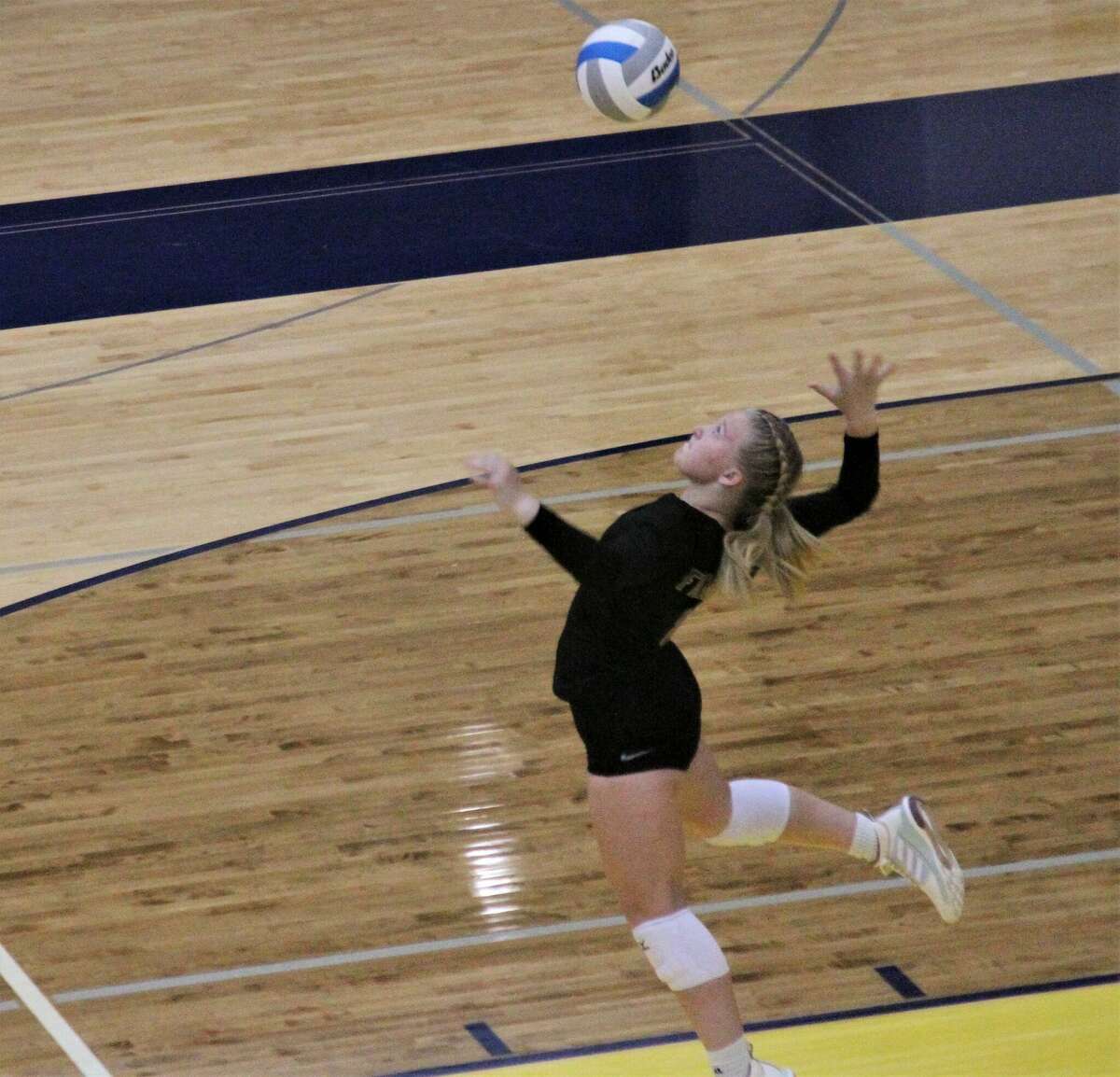 Frankfort senior Kinzee Stockdale braces to serve during a match against Manistee on Sep. 1 at Manistee High School.