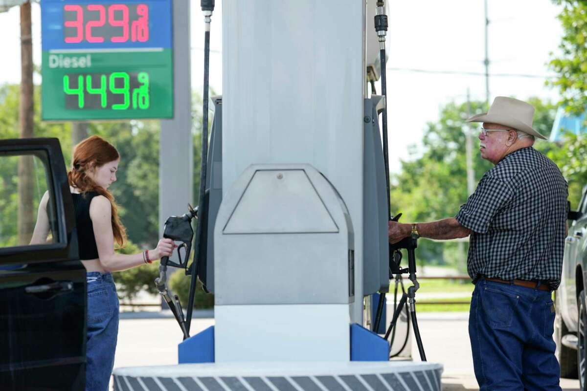 Customers fill their tanks with gas at a station Friday, Sept. 2, 2022 in Liberty.