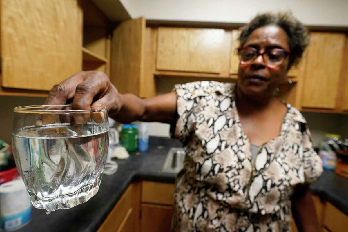 Mary Gaines a resident of the Golden Keys Senior Living apartments displays contaminated water in her kitchen in Jackson, Miss., Thursday, Sept. 1, 2022. A recent flood worsened Jackson's longstanding water system problems.
