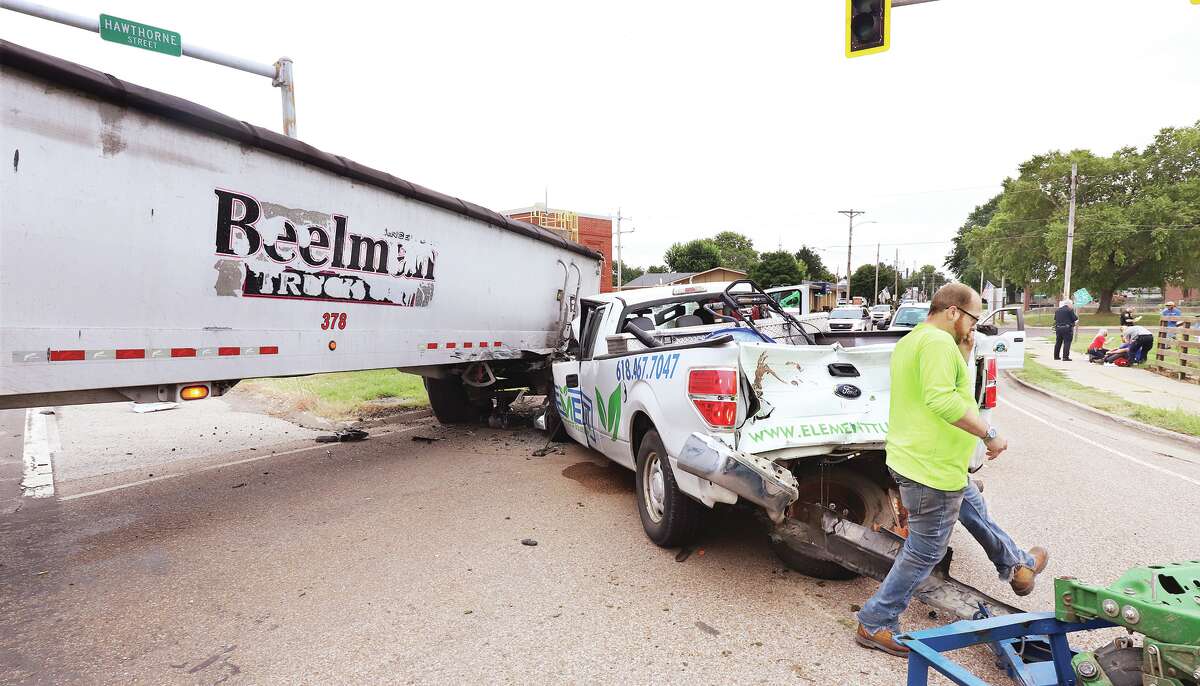 John Badman|The Telegraph The driver of a Beelman Truck Co. semi walks away from a Friday crash in Hartford. The pickup's trailer, with two riding mowers onboard, came loose and slammed into the rear of the vehicle during the crash.