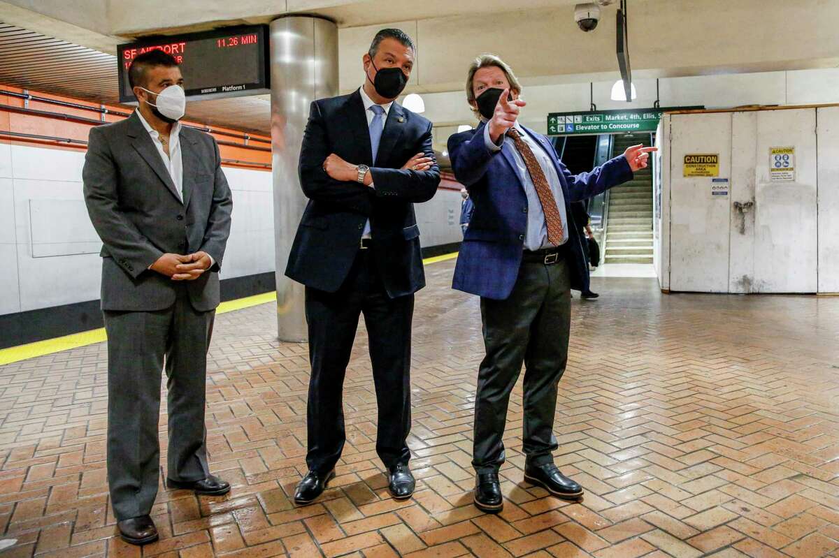 BART general manager Bob Powers points to a new installment of LED lights while on a tour with Sen. Alex Padilla, D-Calif., at Powell Street Station in San Francisco in April.