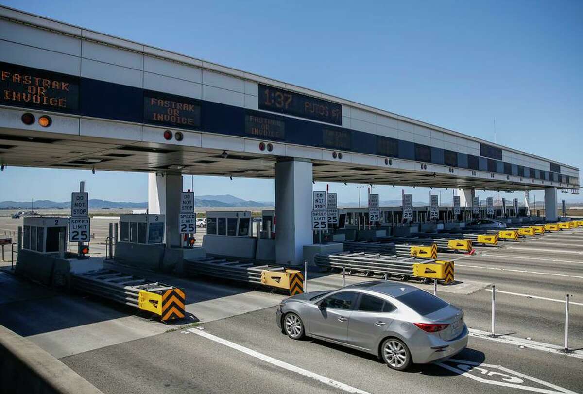 Cars traverse the Bay Bridge toll lanes in Oakland in April. Bridge traffic traditionally declines on holiday weekends.