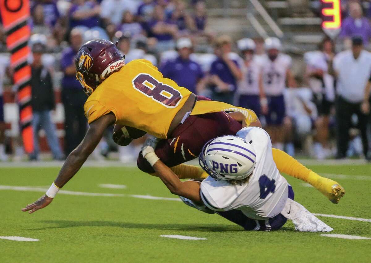 Port Neches-Groves defensive back Dylan Lawless tackles Beaumont United quarterback Jonathan Martin during a game Friday night. 