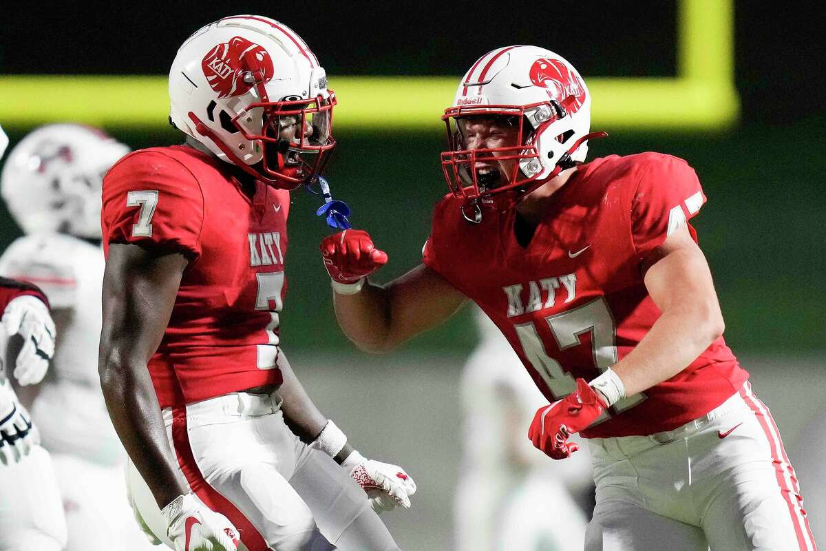 Katy linebacker Chisholm Hill, right, celebrates his sack of Atascocita quarterback Zion Brown with Johnathan Hall during the first half of a high school football game, Friday, Sept. 2, 2022, in Katy, TX.