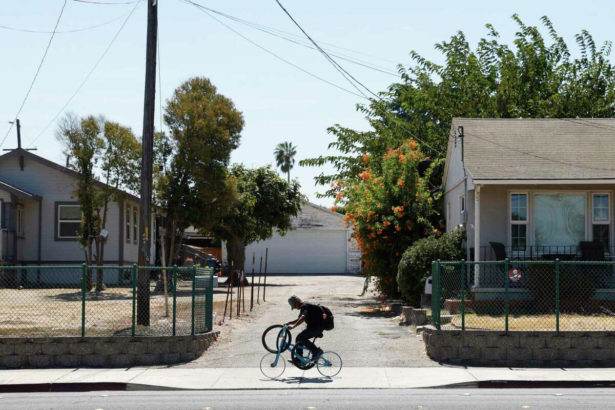 A cyclist rides with a spare tire along East 18th Street in Antioch.