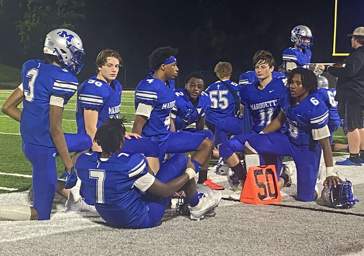 Marquette players huddle together on the sideline while teammate Nate Hamberg was being treated by medical personnel in the second half of Friday's loss to Salem at Public School Stadium.