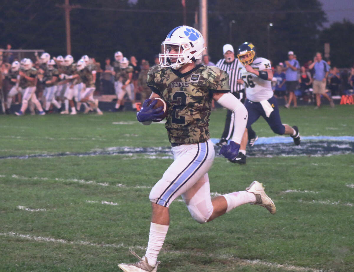 Jersey's Logan Meisner returns the interception for a touchdown against Marion on Friday. Jersey wore camouflage uniforms supplied by the Illinois National Guard. 