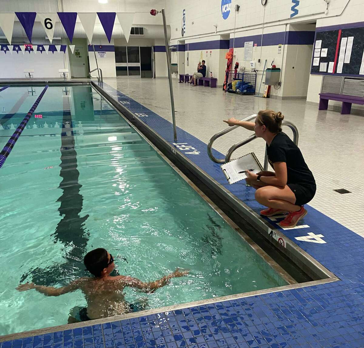 Trumbull Pisces coach Jess Daigle instructs a swimmer during tryouts on Aug. 30, 2022 at the University of Bridgeport.