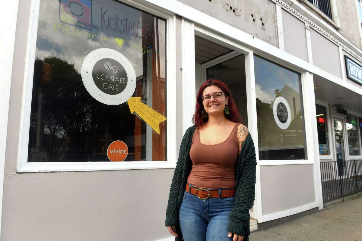 Owner Stephanie Champagne poses in front of Kickstart Café, that will open soon in Shelton, Conn. Aug. 29, 2022.