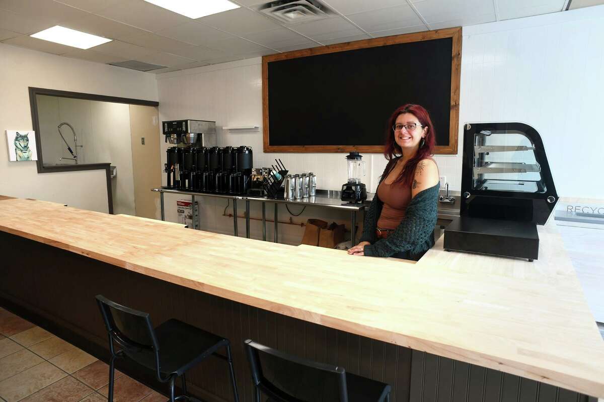 Owner Stephanie Champagne poses inside of Kickstart Café, that will open soon in Shelton, Conn. Aug. 29, 2022.