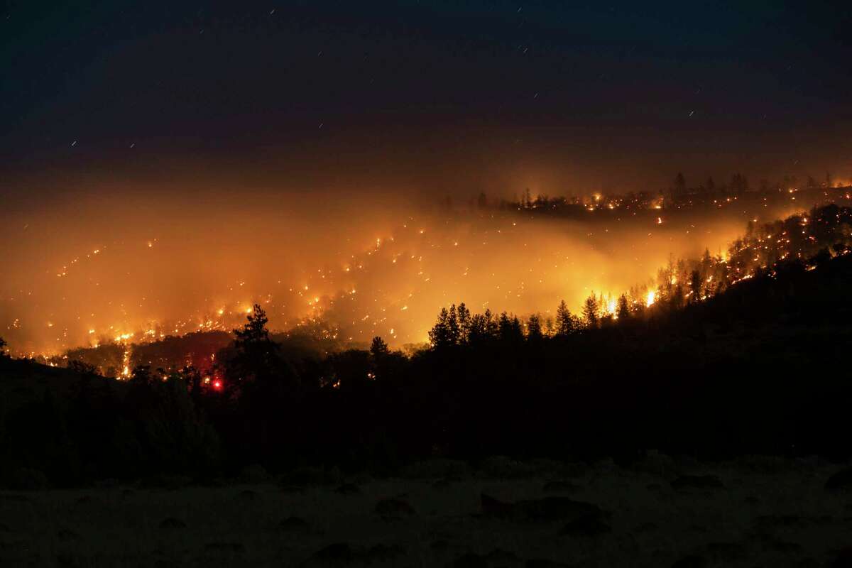 The Mill Fire is seen burning from a distance in Weed, Calif. Friday, Sept. 2, 2022.