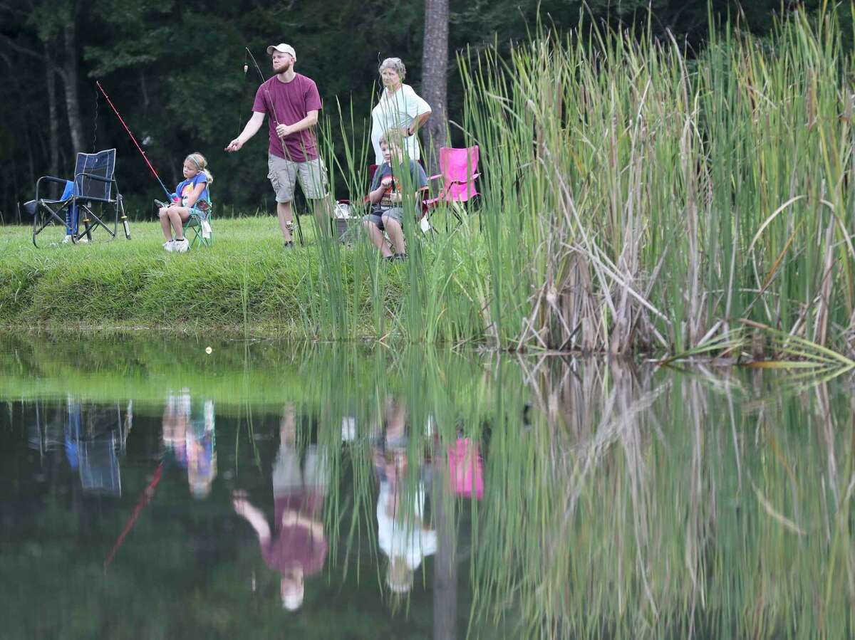 Families fish at Creekwood Park during the annual The Woodlands Kiwanis Club’s kid fishing tournament, Saturday, Sept. 3, 2022, in The Woodlands.