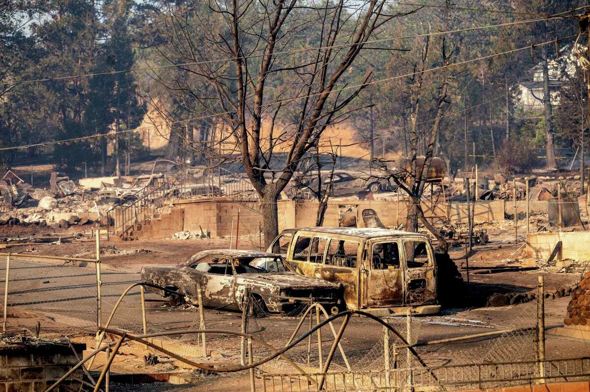 Vehicles and and homes destroyed by the Mill Fire line a neighborhood in Weed, Calif., on Saturday, Sept. 3, 2022.