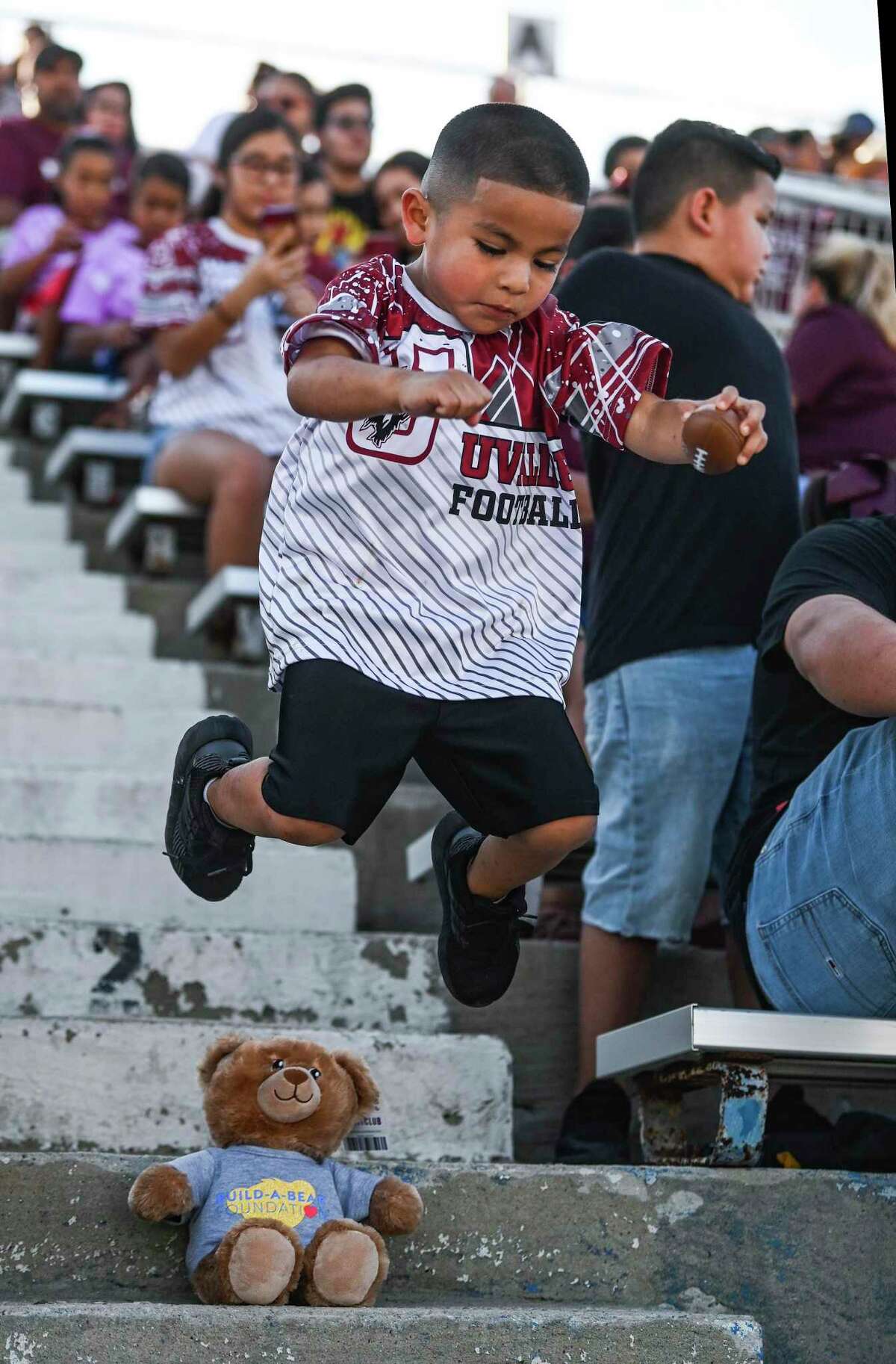 Angel Gonzalez, 4, plays with his plush bear in the stands at Honey Bowl Stadium in Uvalde, where the Uvalde Coyotes played their first home game of the football season on Friday night, Sept. 2, 2022, just over three months after 22 students and teachers were gunned down at Robb Elementary School in Uvalde. Uvalde won the game over Eagle Pass Winn, 34-28.