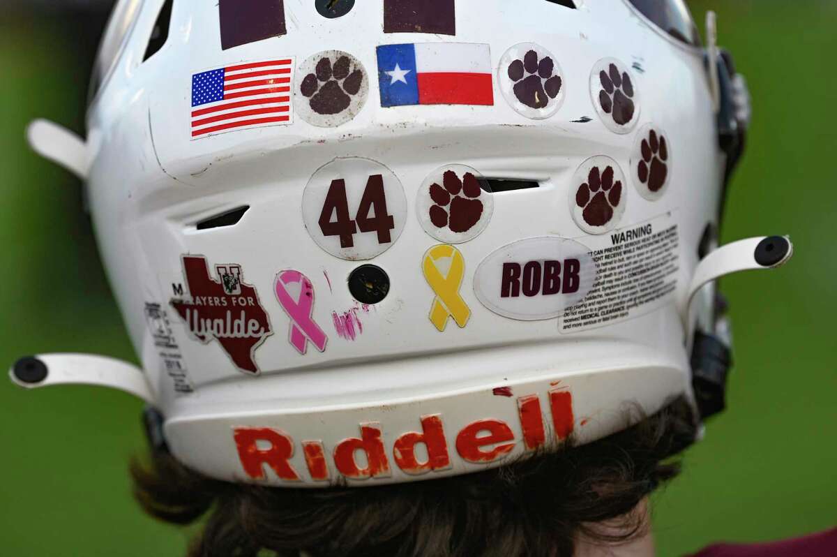 The Uvalde football team helmets are emblazoned with decals remembering the 21 students and teachers who died in a mass shooting at Robb Elementary School on May 24. The Uvalde Coyotes beat Eagle Pass Winn at Honey Bowl Stadium on Friday night, Sept. 2, 2022.