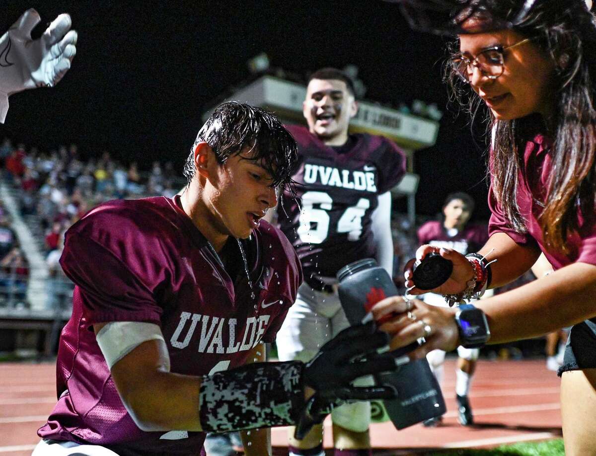 Tired Uvalde senior Jayden Gonzalez cools off after his team scored the touchdown to defeat Eagle Pass Winn, 34-28, at Honey Bowl Stadium on Friday night Sept. 2, 2022, just over three months after 21 students and teachers were gunned down at Robb Primary School in Uvalde. The game was the team's first home game of the season.