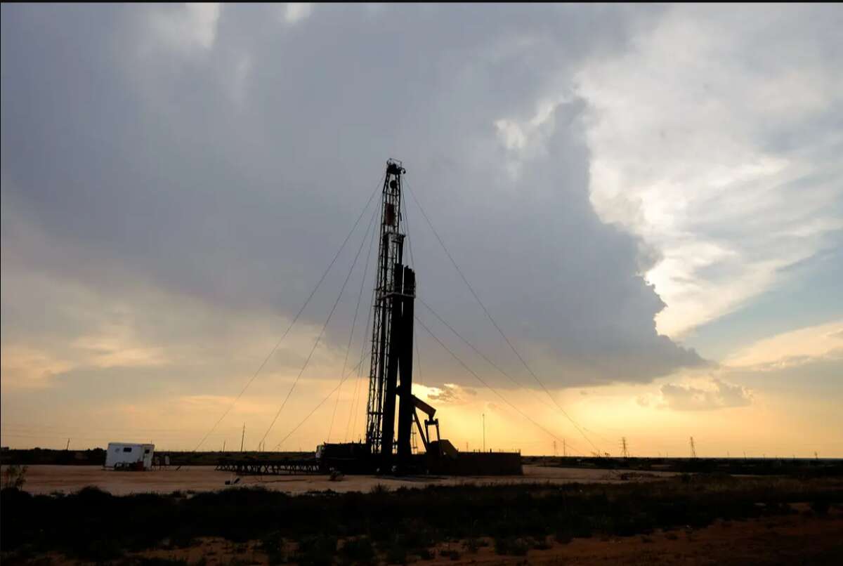 A drilling rig at sunset operates on the north side of Midland in 2016.