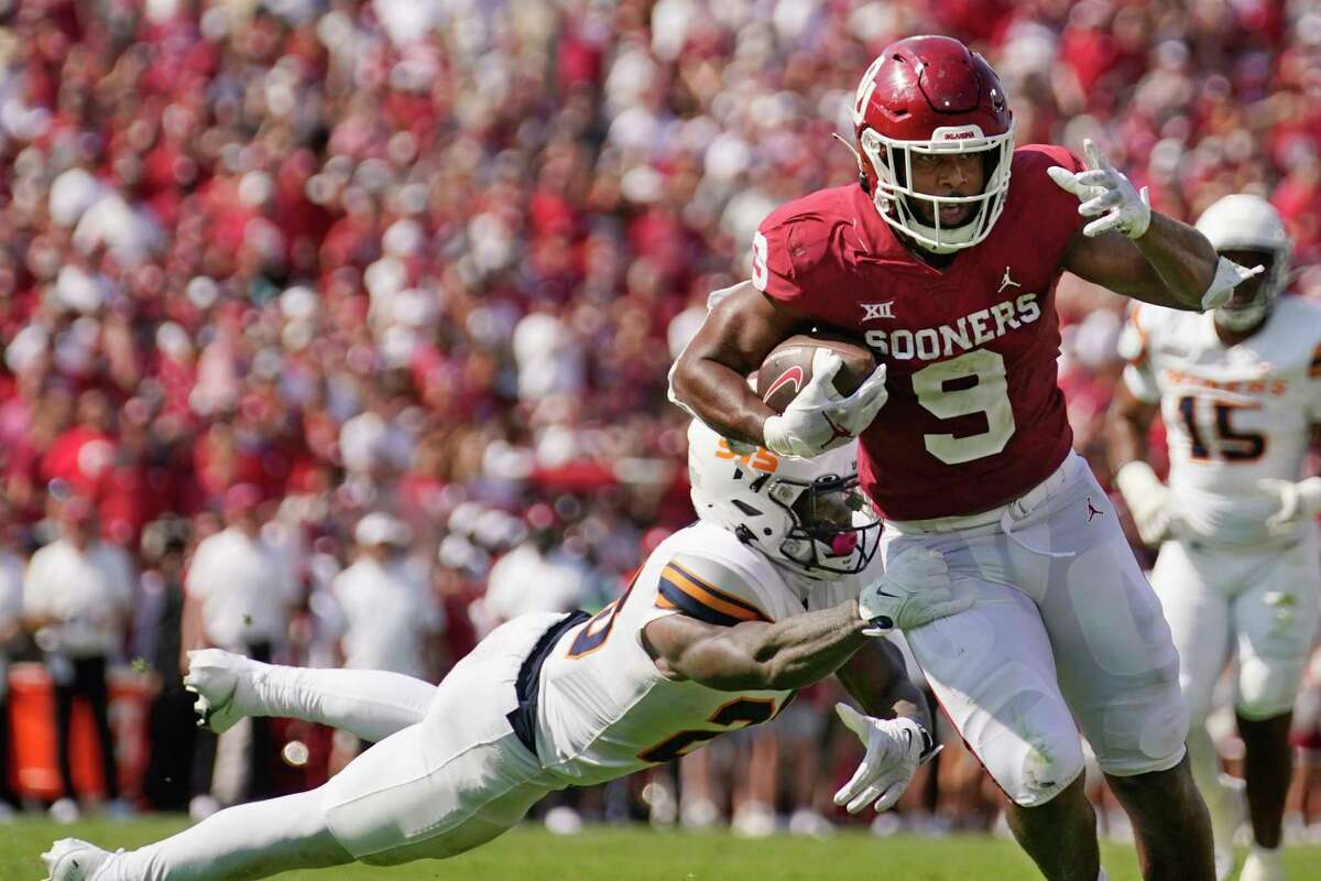 Oklahoma tight end Brayden Willis (9) avoids a tackle by UTEP defensive back Darius Baptist, left, and takes a Dillon Gabriel pass into the end zone for a touchdown in the first half of an NCAA college football game, Saturday, Sept. 3, 2022, in Norman, Okla.