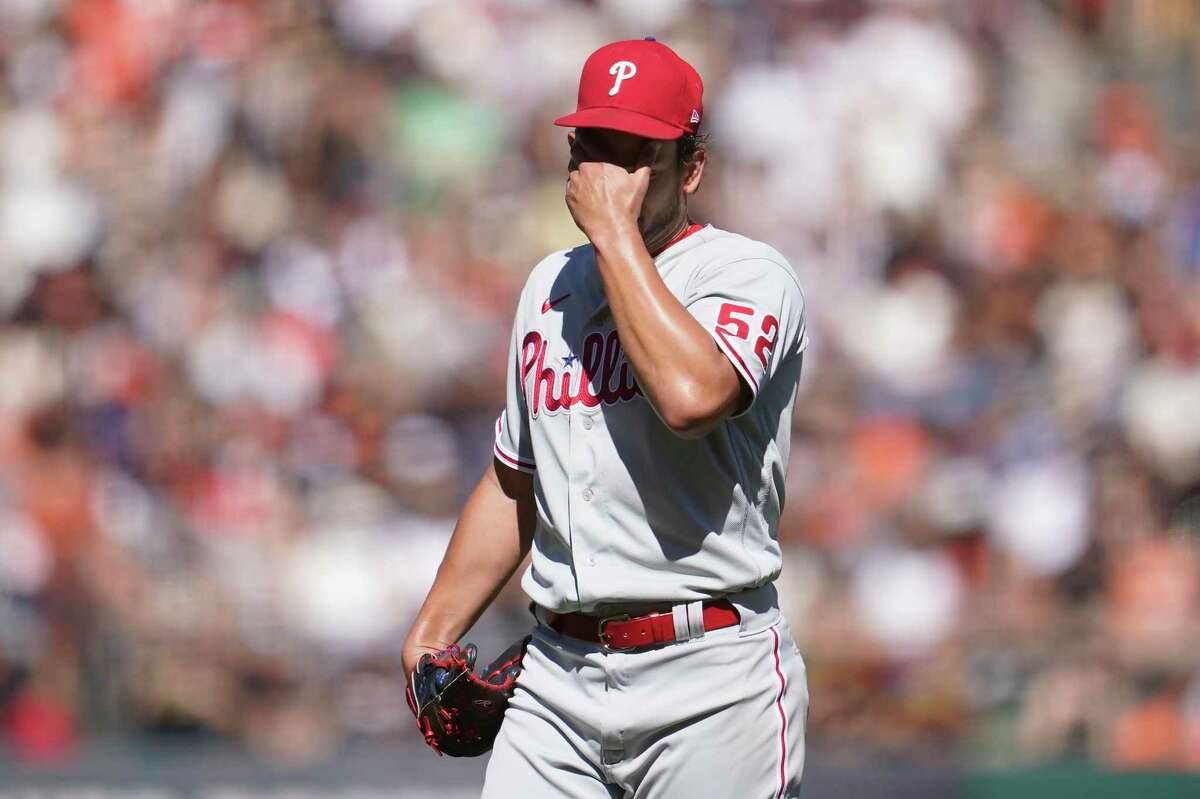Philadelphia Phillies pitcher Brad Hand reacts after walking San Francisco ...