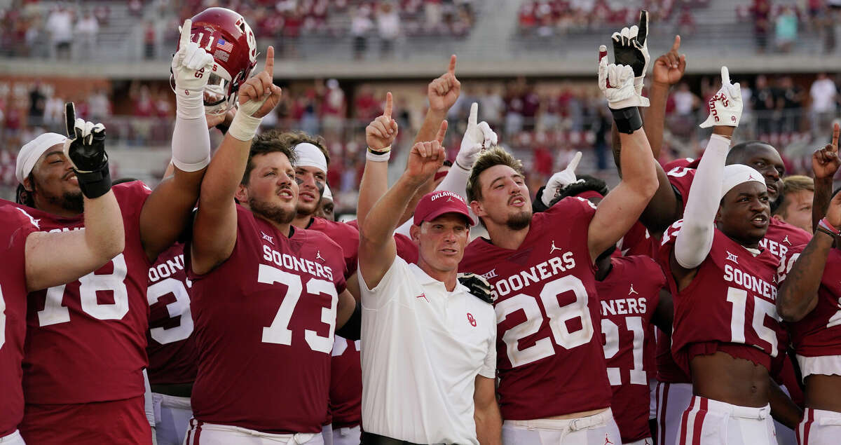 Oklahoma head coach Brent Venables, center, celebrates with his players after they defeated UTEP in an NCAA college football game, Saturday, Sept. 3, 2022, in Norman, Okla. (AP Photo/Sue Ogrocki)