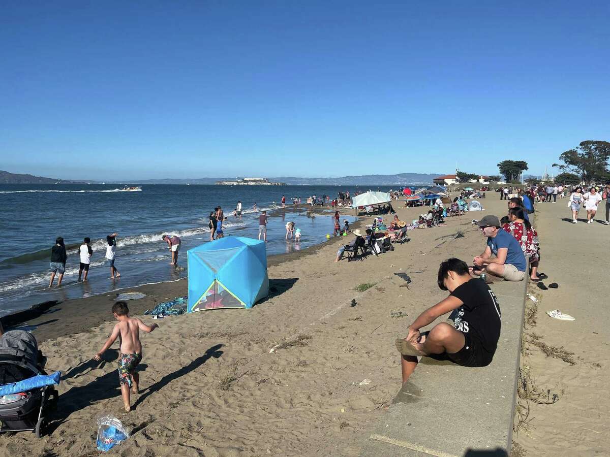 San Francisco’s Crissy Field Beach draws a crowd Saturday as temperatures continue to rise during a heat wave that has officials concerned about illnesses and wildfires.