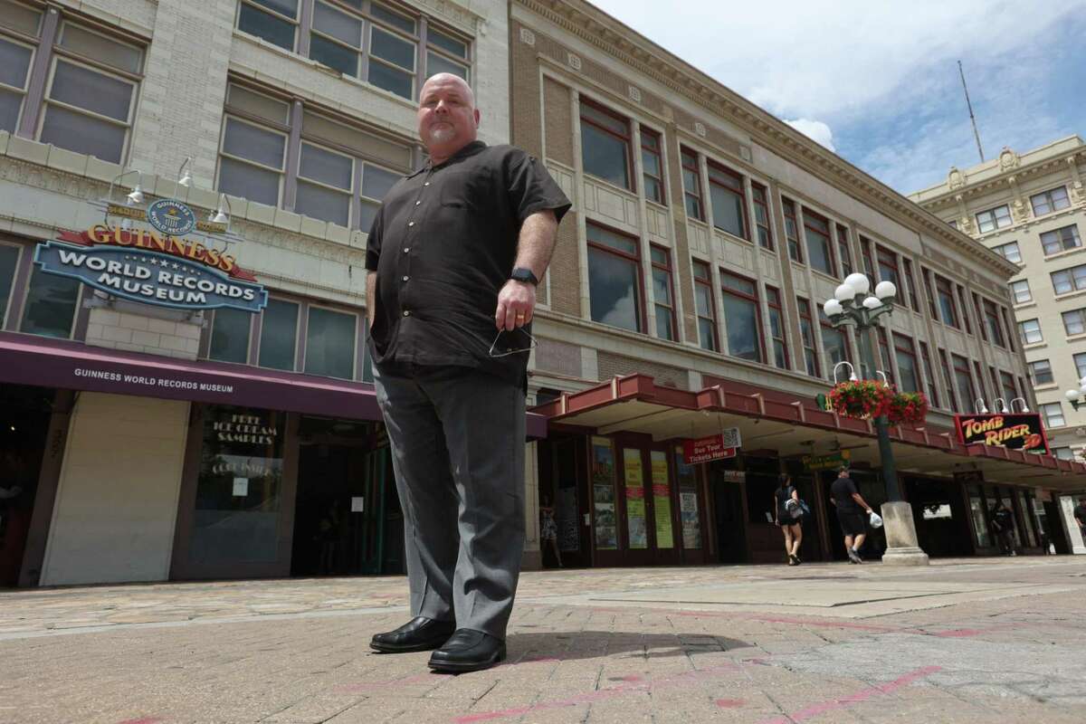 Davis Phillips, president and CEO of Phillips Entertainment, poses on September 1, 2022 in front of the company's three businesses in the Palace and Woolworth buildings in Alamo Plaza that will close after Labor Day.