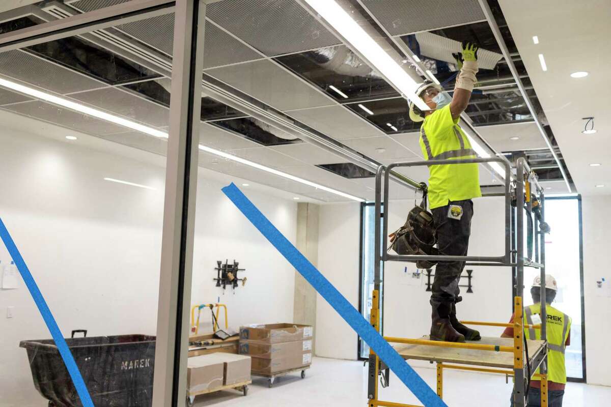 Construction crews work to install ceiling tiles in UTSA's School of Data Science in San Antonio, TX, on June 17, 2022.