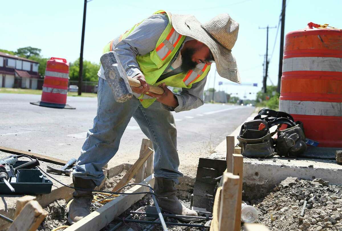 Erick Bryan swings a sledgehammer while working on a street project along Commerce and SW 19th streets in June 2022.