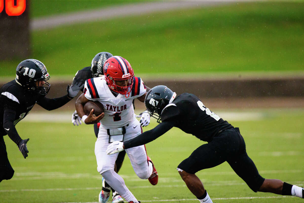 Alief Taylor QB Chase Jenkins (4) is pressure by Westside LB Joshua Robinson (10) and DB Jaiden McKinney (2) in the first half of action during a high school football game non-district game between Alief Taylor vs Westside at Delmar Stadium in Houston, TX, September 03, 2022.