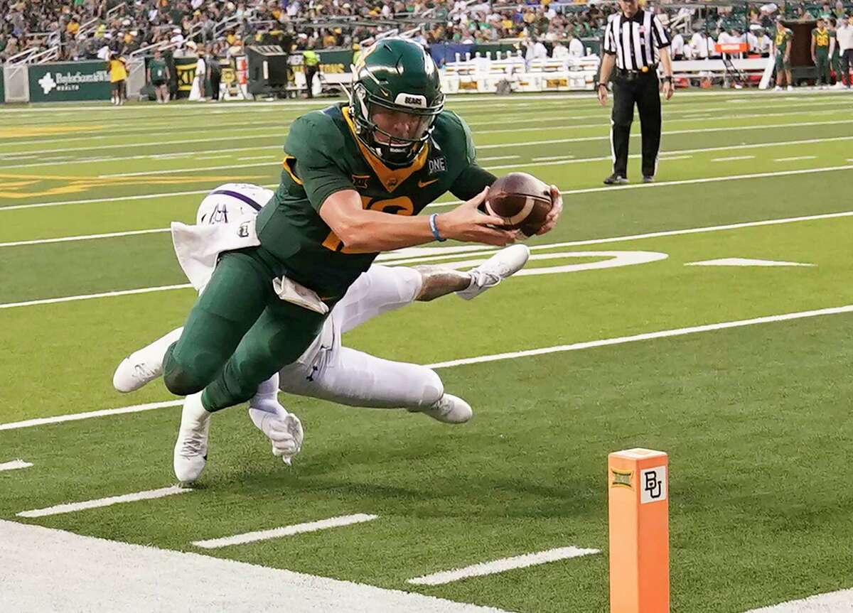 Baylor quarterback Blake Shapen (12) dives to score a touchdown against Albany defensive back Isaac Duffy (19) during the first half of an NCAA college football game in Waco, Texas, Saturday, Sept. 3, 2022.