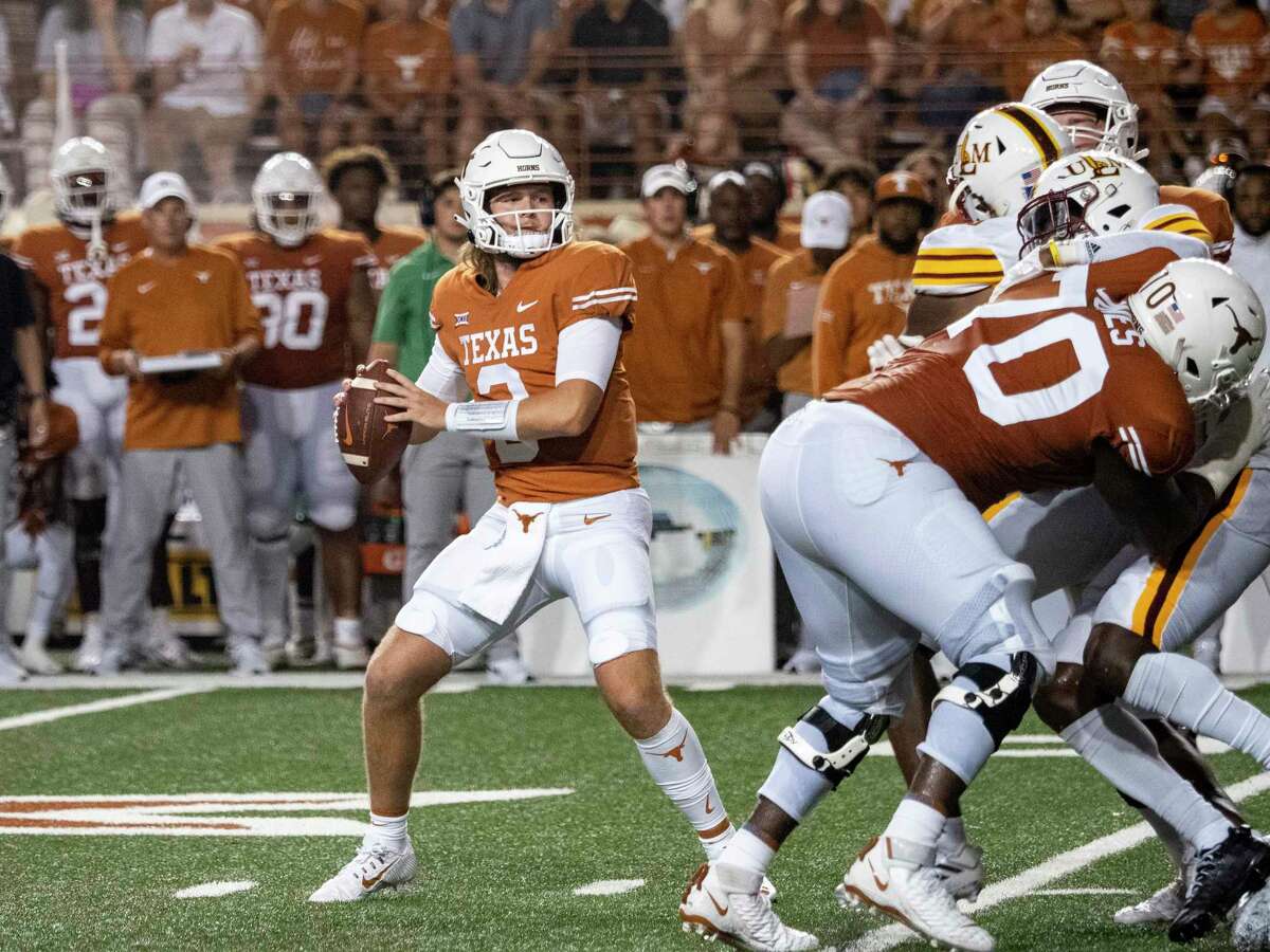 Texas quarterback Quinn Ewers, front left, looks to pass during the first half of an NCAA college football game against Louisiana-Monroe, Saturday, Sept. 3, 2022, in Austin, Texas. (AP Photo/Michael Thomas)