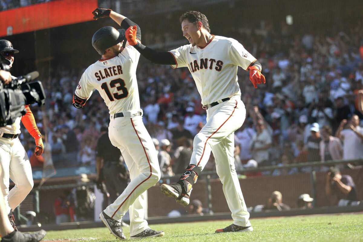 San Francisco Giants’ Wilmer Flores and Austin Slater celebrate Flores’ walk off 2-run home run giving Giants a 5-3 win over Philadelphia Phillies during MLB game at Oracle Park in San Francisco, Calif., on Sunday, September 4, 2022.