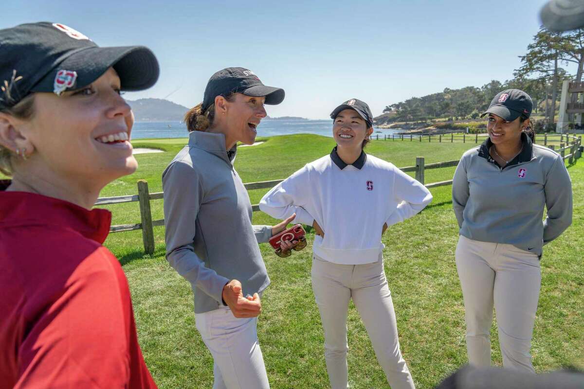 At center left, Stanford women's golf head coach Ann Walker, talks to the team after the Carmel Cup event at the Pebble Beach Golf Club on Saturday, Sept. 3, 2022 in Pebble Beach, Calif. Stanford women's golfers, from left, are Rachel Heck, Rose Zhang and Megha Ganne.