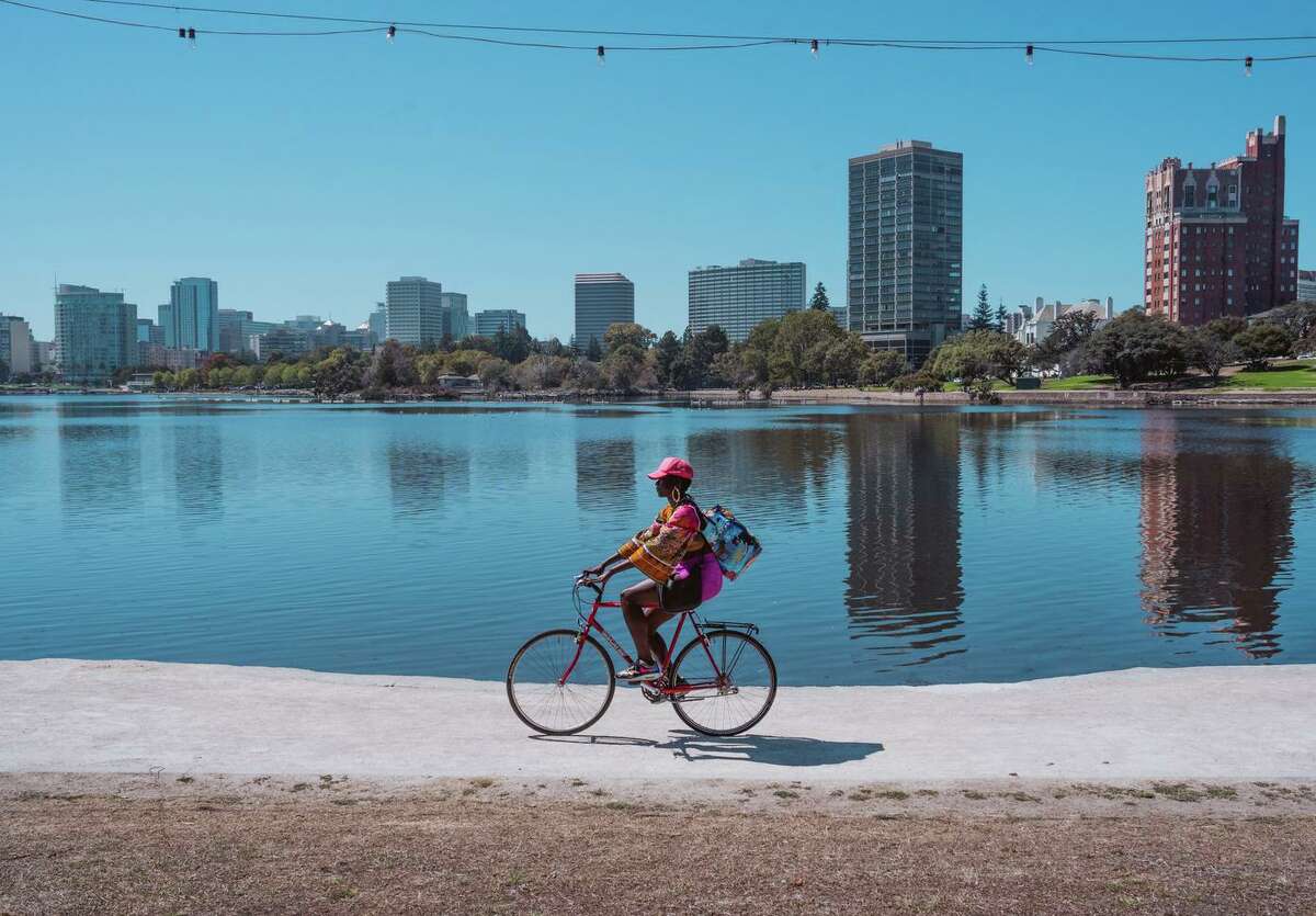 A biker rides by Lake Merritt during the heat wave on Labor Day weekend in Oakland.