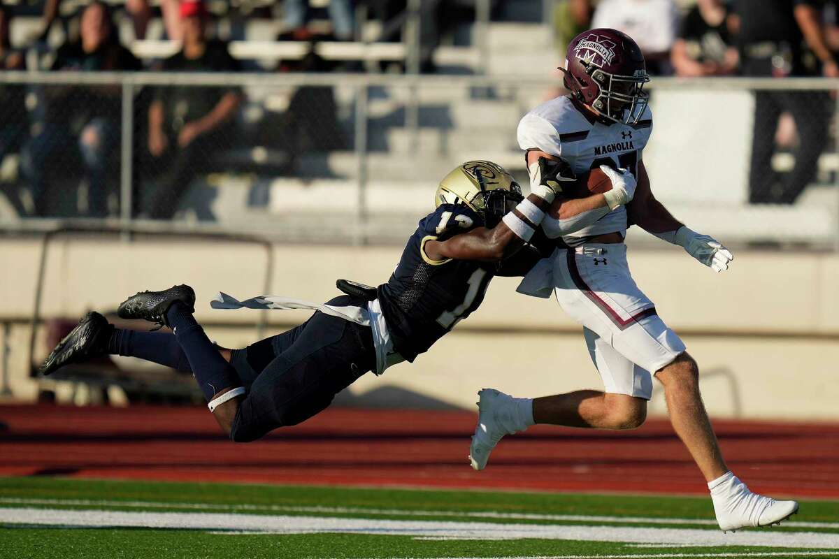 Magnolia running back Hunter Andrews, right, is tackled by Klein Collins defensive back Elijah Boone during the first half of a high school football game, Saturday, Aug. 27, 2022, in Klein.