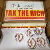 Tax The Rich bumper stickers on sale at the annual Labor Day Picnic held by the Solidarity Committee of the Capital District at Cook Park in Colonie, NY, on Monday, Sept. 5, 2022 (Jim Franco/Special to the Times Union)
