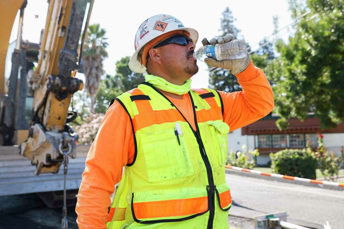 Construction worker Gabriel Caballero drinks water while working along Fitzuren Road as temperatures rise in Antioch, Calif. Thursday, Sept. 1, 2022.