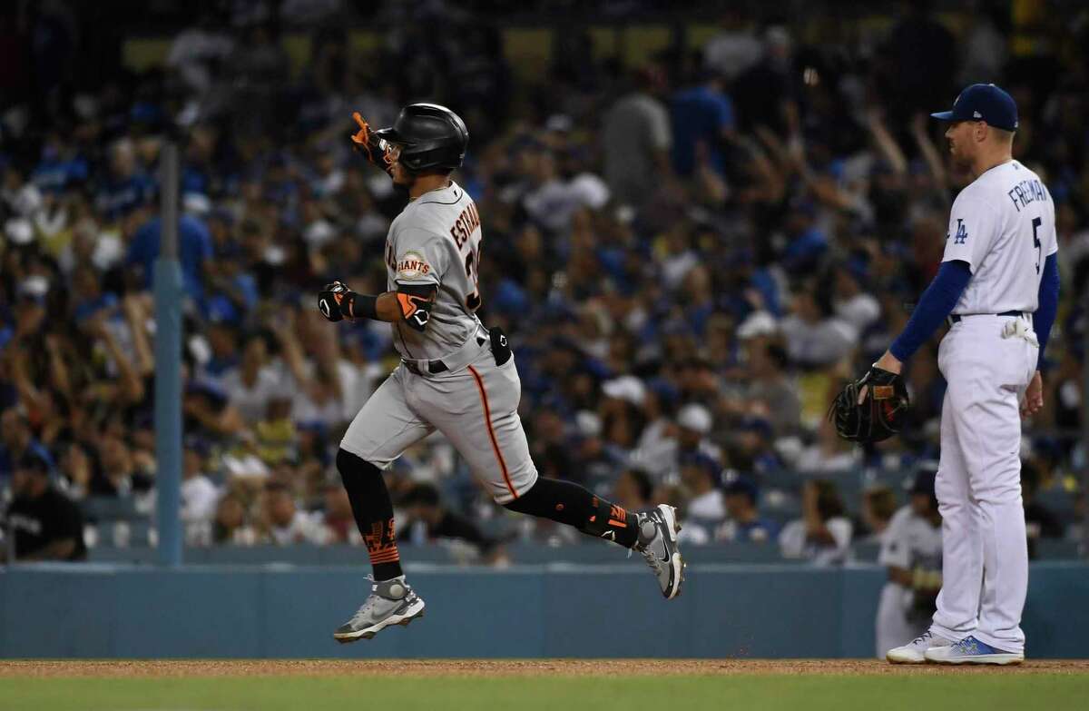 LOS ANGELES, CA - SEPTEMBER 05: Thairo Estrada #39 of the San Francisco Giants celebrates after hitting a one run home run against stating pitcher Andrew Heaney #28 of the Los Angeles Dodgers during the fourth inning at Dodger Stadium on September 5, 2022 in Los Angeles, California. (Photo by Kevork Djansezian/Getty Images)
