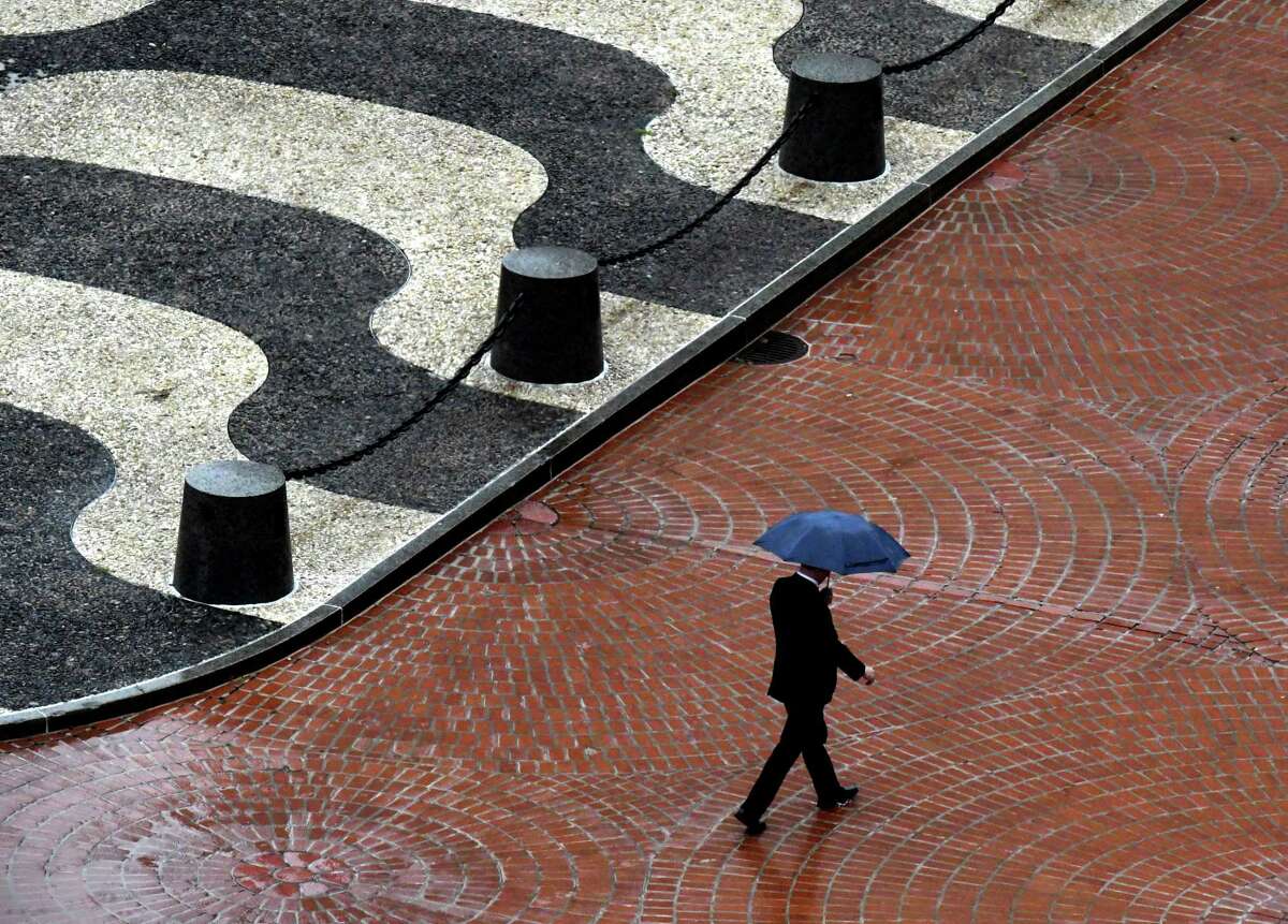 Heavy rain might melt snow pack and cause flooding conditions Friday, Dec. 23, 2022, in some Capital Region localities. Empire State Plaza, pictured, gets a good soaking of rain as a man shields himself from the steady drizzle on Tuesday, Sept. 6, 2022, in Albany, N.Y. 
