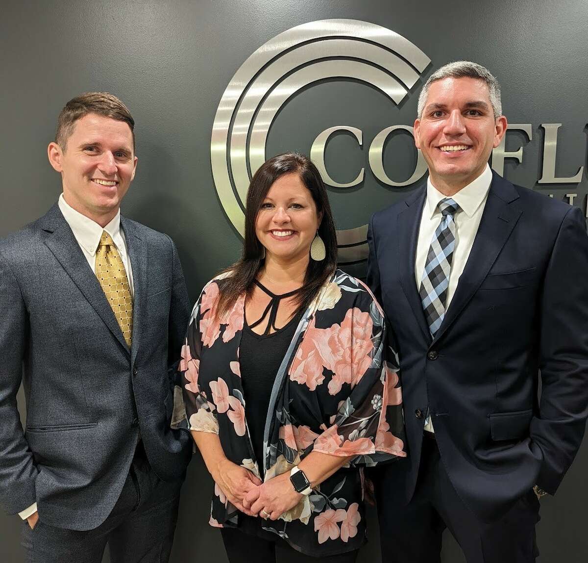 From left are Jack Hoelscher, Jennifer Mobley and Robert Diaz of Confluence Wealth Management in Alton.