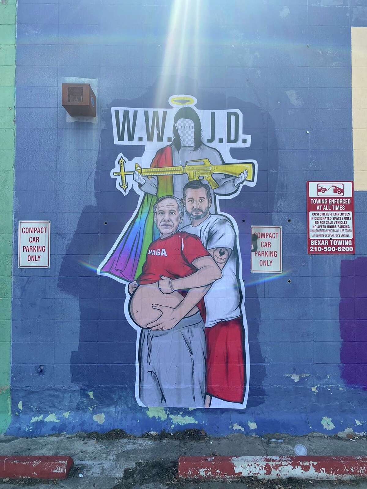 A massive sticker appeared in Southtown showing a pregnant Greg Abbott and Ted Cruz as his partner popped up on the side of an abandoned building.