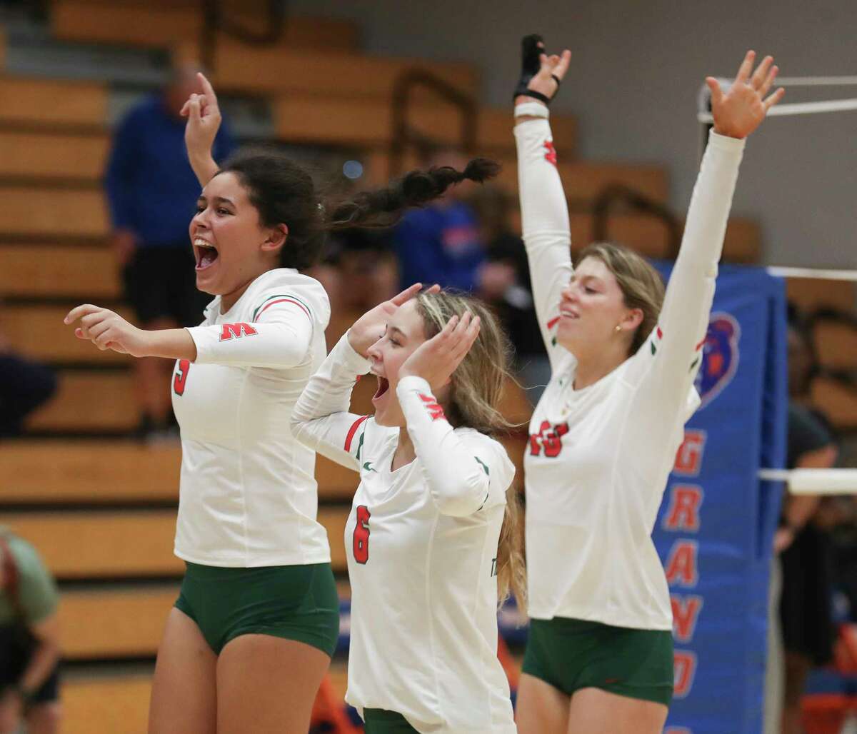 The Woodlands celebrates after defeating Grand Oaks 25-23 in five sets during a District 13-6A high school volleyball match at Grand Oaks High School, Tuesday, Sept. 6, 2022, in Spring.