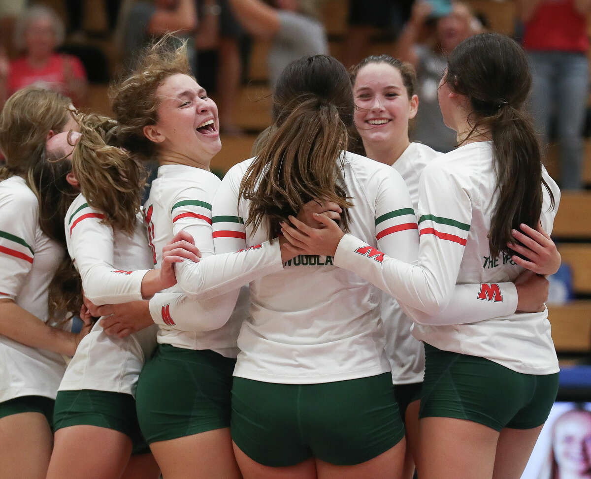 The Woodlands celebrates after defeating Grand Oaks 25-23 in five sets during a District 13-6A high school volleyball match at Grand Oaks High School, Tuesday, Sept. 6, 2022, in Spring.