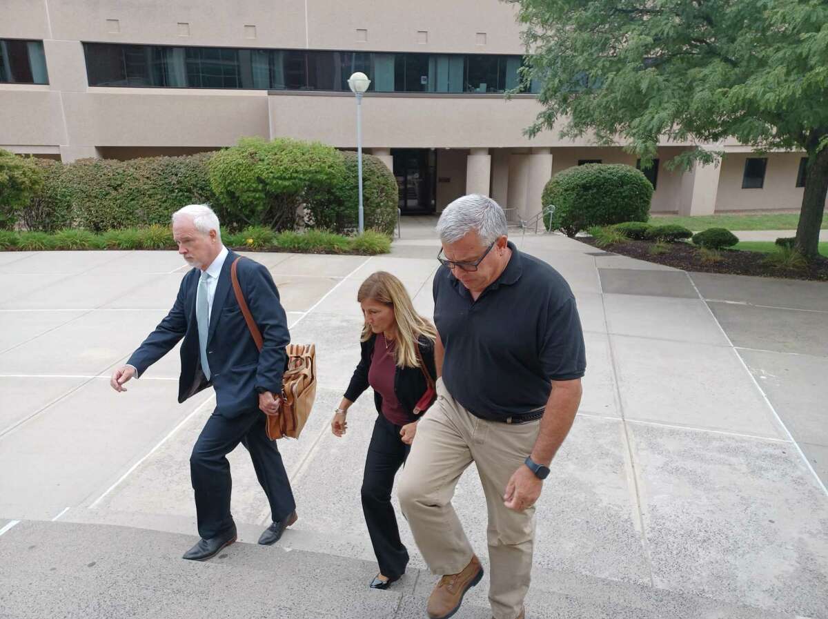 Sherri Turner, center, who served as Plymouth Center School’s principal, arrives at state Superior Court in New Britain on Wednesday, Sept. 7, 2022. Turner has been charged with failure to report the abuse, neglect or injury of a child or imminent risk of serious harm to a child. She allegedly failed to report the alleged sexual abuse perpetrated by fourth grade teacher James Eschert.