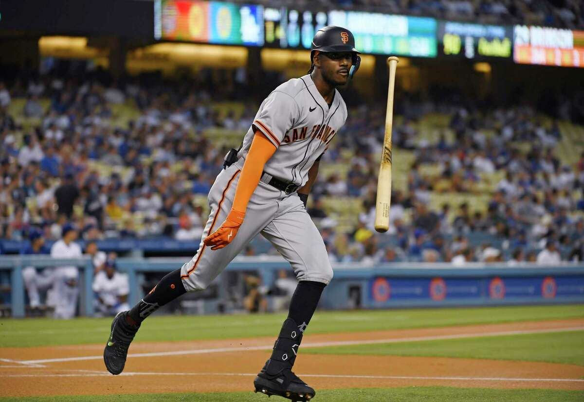 San Francisco Giants' Lewis Brinson, in front, reacts after