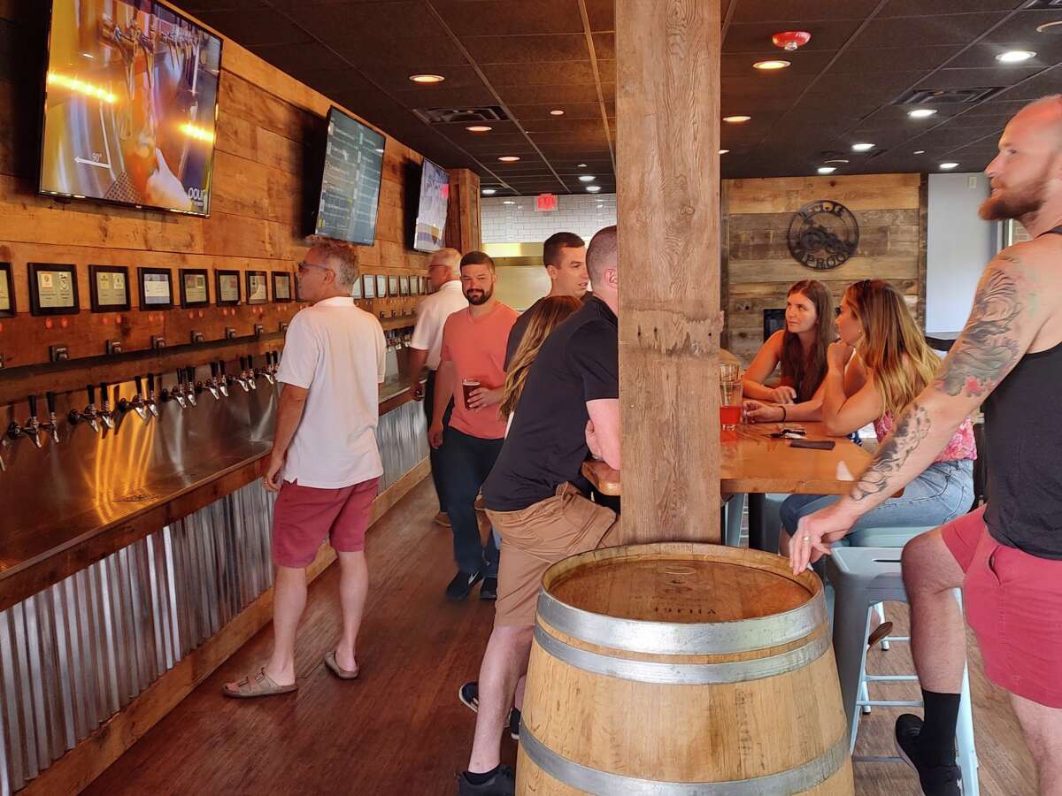 Customers experience the self-pour technology at the soft opening of Tri-It Taproom in Avon. 