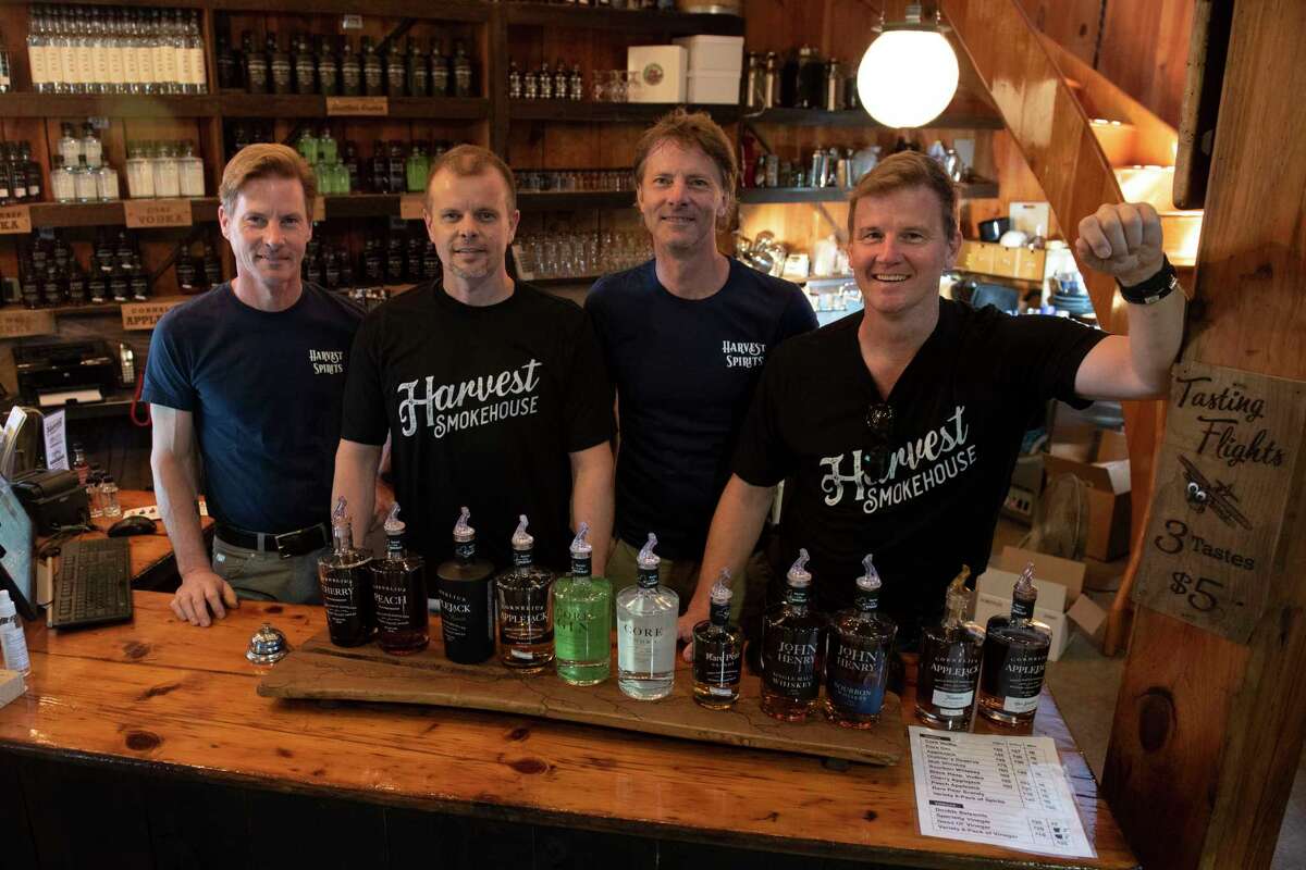 From left, co-owner Grout brothers Derek, Darren, David and Doug stand behind a counter in the distillery at Golden Harvest Farms on Friday, Sept. 2, 2022 in Valatie, N.Y.